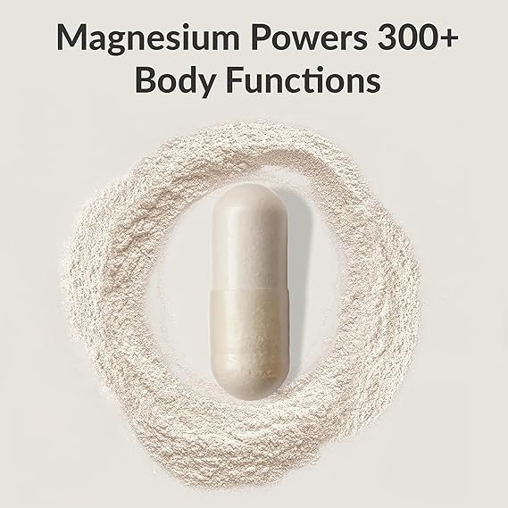 Supplement pill surrounded by magnesium powder with text about magnesium's functions on a light background