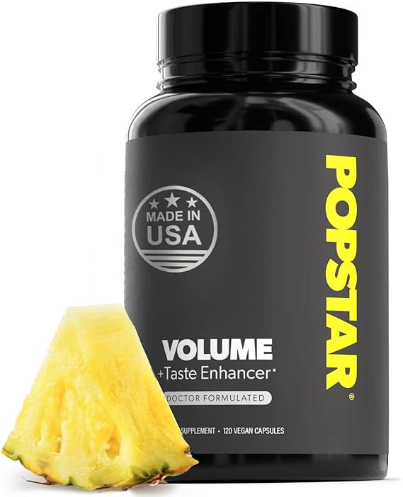 Black supplement bottle labeled 'Popstar Volume' with a pineapple wedge on a white background