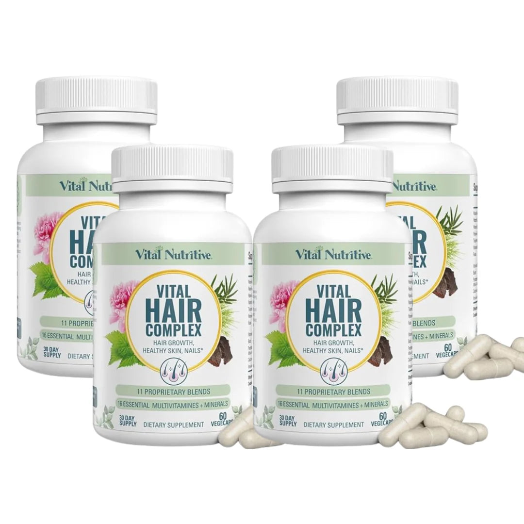 Four bottles of Vital Nutriive Hair Complex with scattered capsules on a white background
