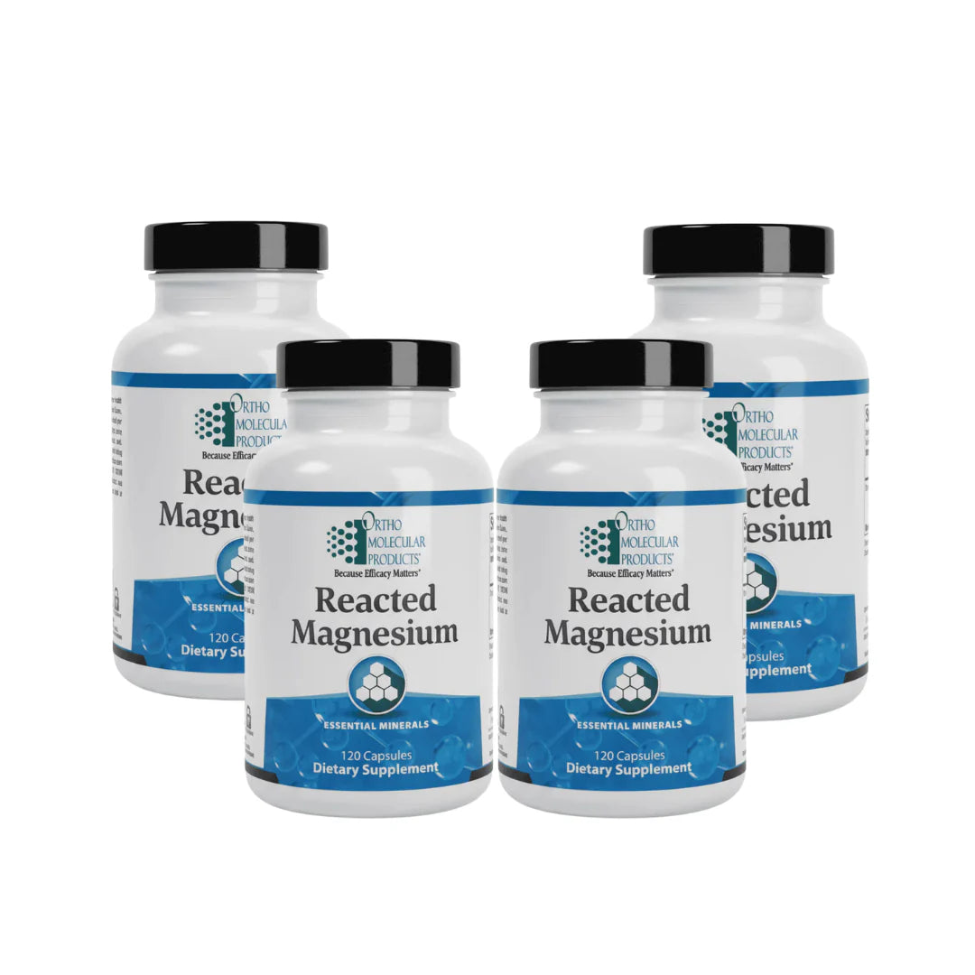 Four bottles of Reacted Magnesium dietary supplements on a white background