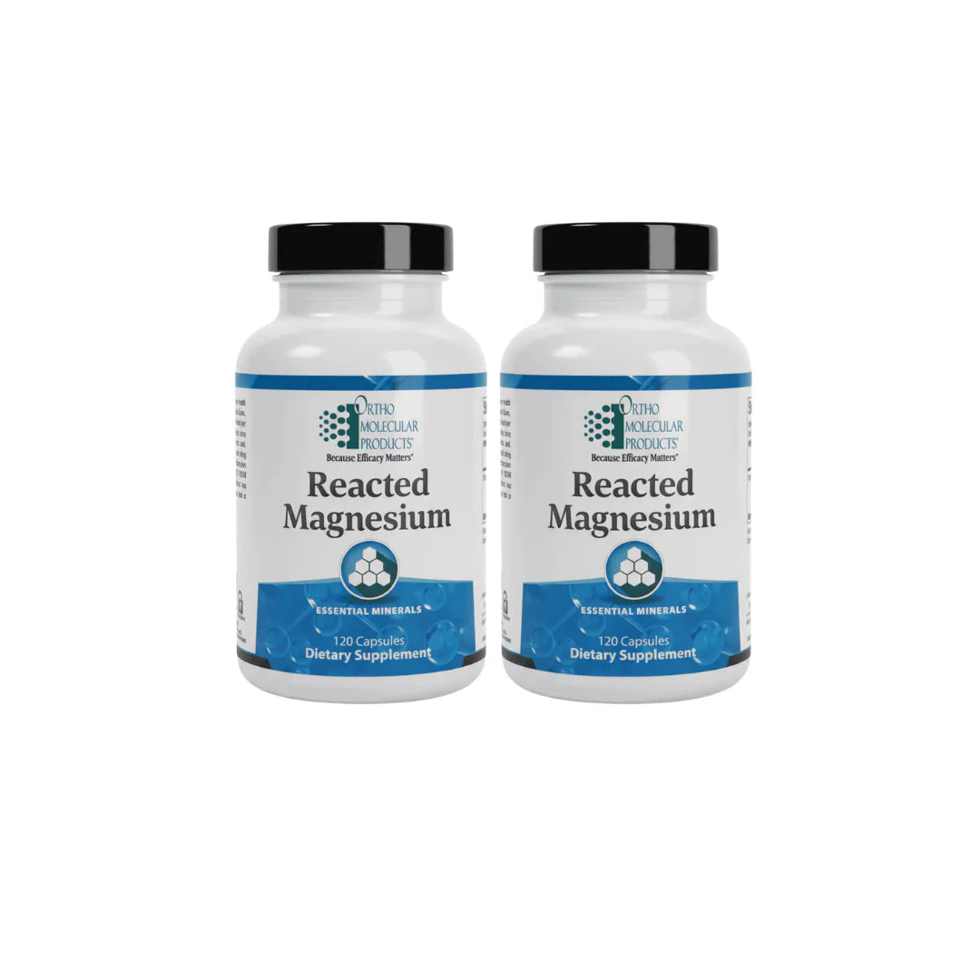 Two bottles of Reacted Magnesium supplement on a white background